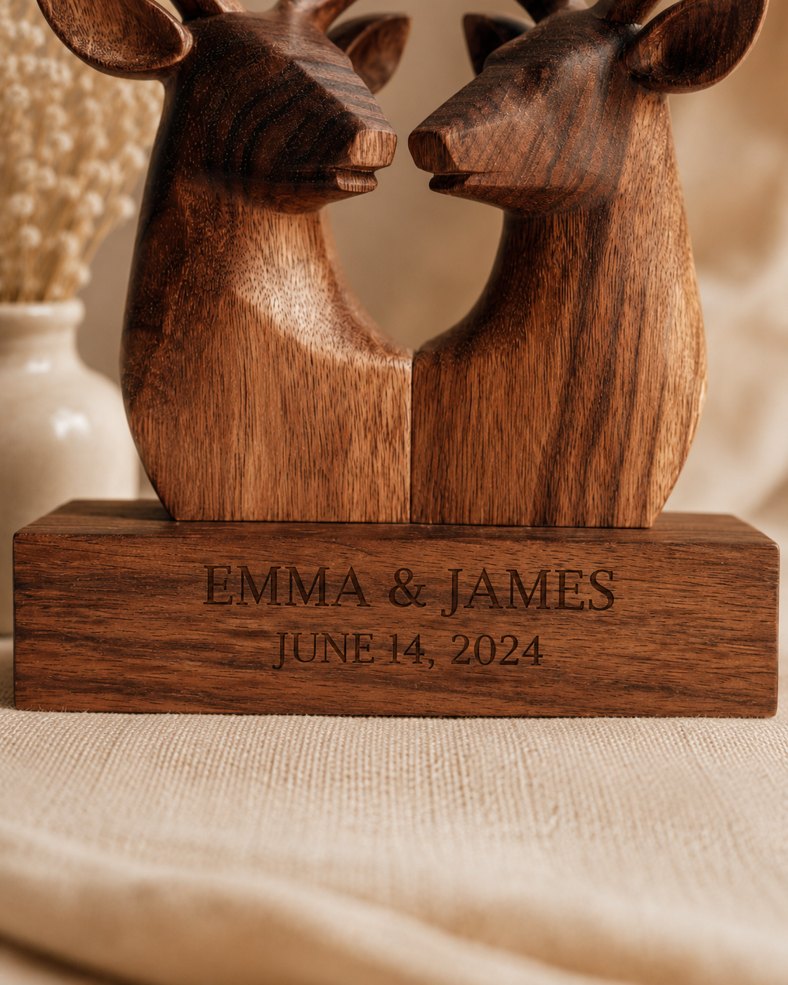Close-up of engraved names and date on walnut deer sculpture base