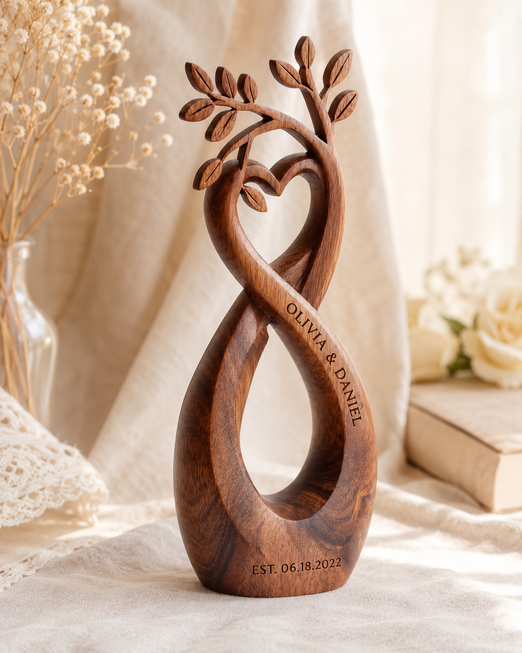 Walnut infinity heart sculpture, three-quarter view, styled with baby's breath and roses