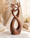 Walnut infinity heart sculpture, three-quarter view, styled with baby's breath and roses