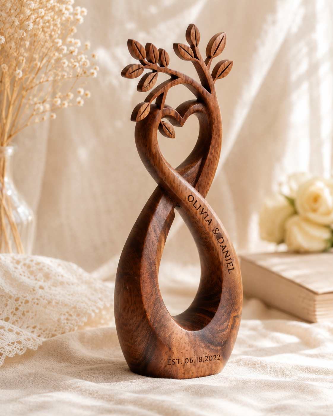 Walnut infinity heart sculpture, side view on lace tablecloth with roses