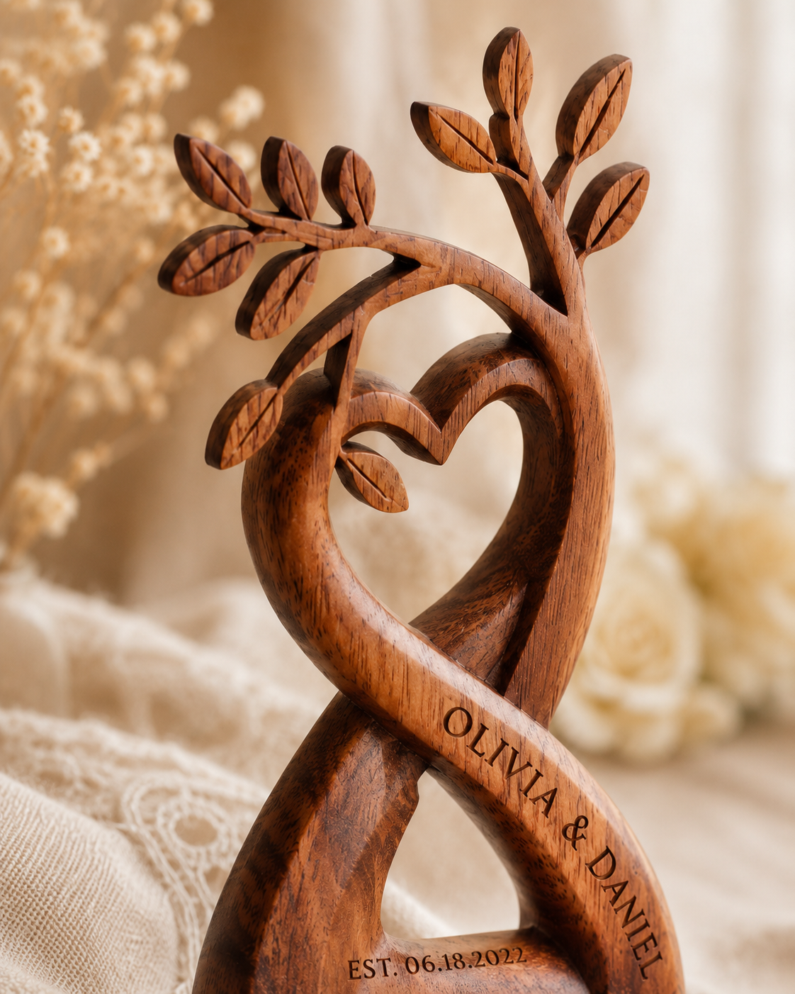 Close-up of hand-carved tree leaves and heart detail in walnut