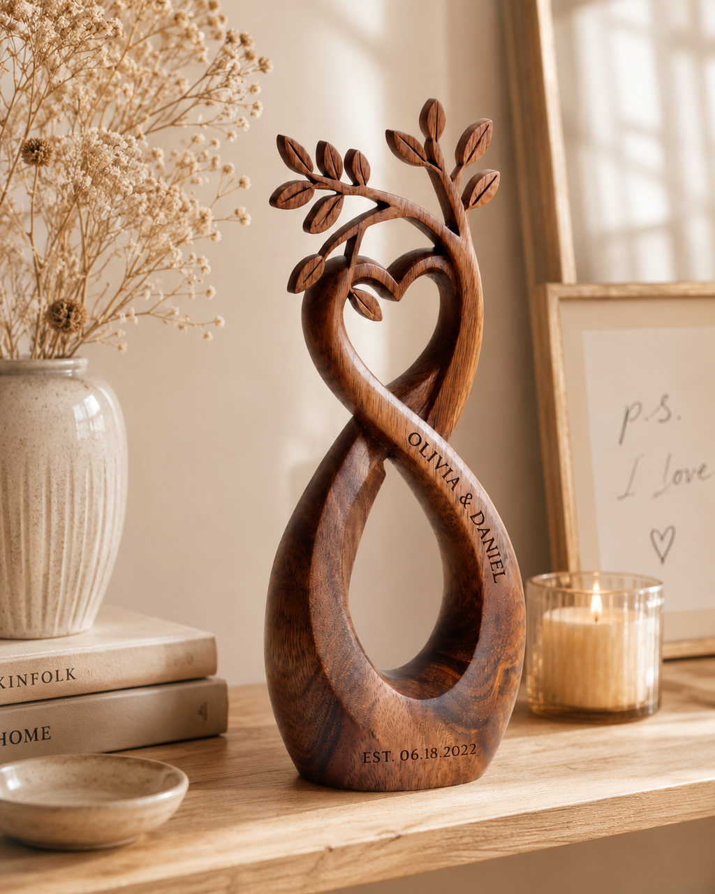 Walnut infinity heart on wooden shelf with candle and framed art
